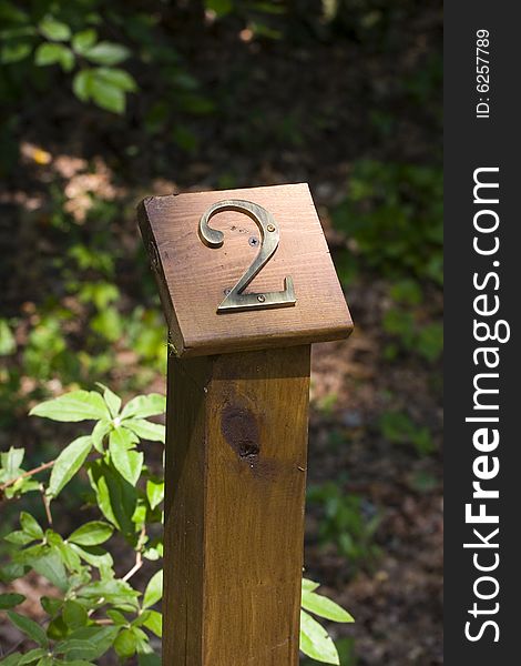 A wooden trail marker in a woodland park. A wooden trail marker in a woodland park