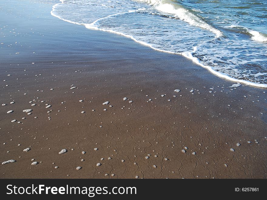 Close-up shot of Sand and Wave. Close-up shot of Sand and Wave