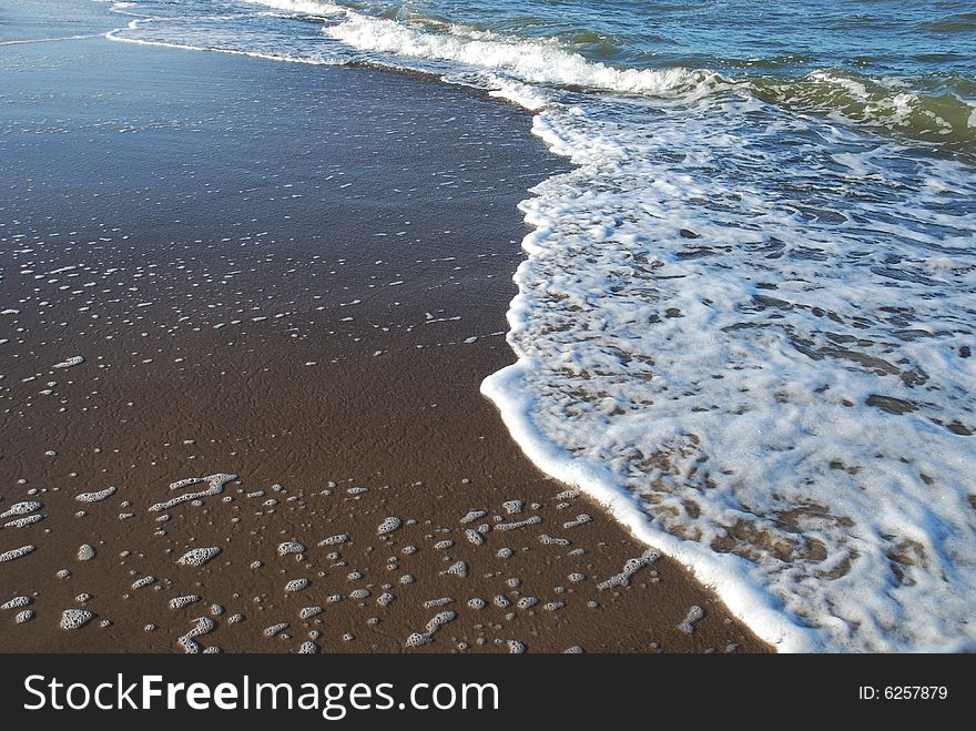 Close up shot of Wave and Sand. Close up shot of Wave and Sand