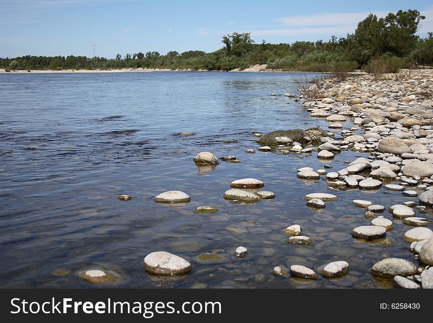 The passing of the river and the rocks on shore