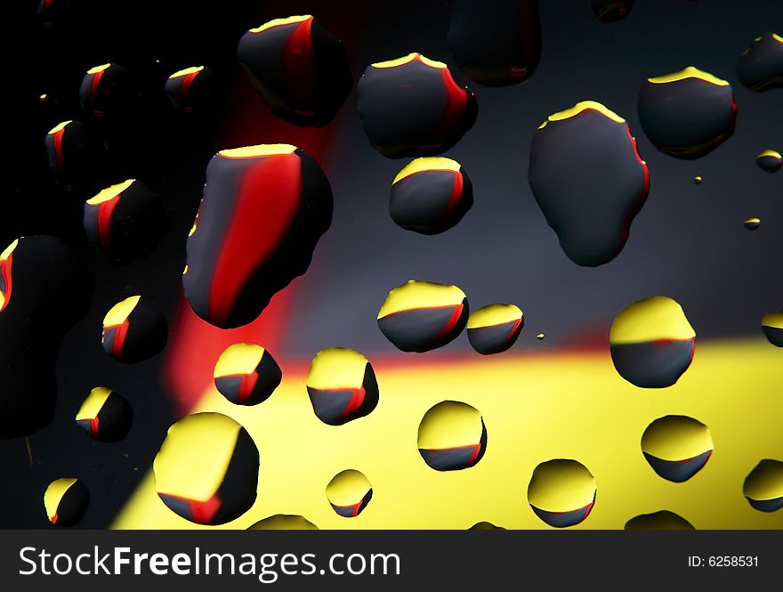 Water drops on glass with a multi-coloured background
