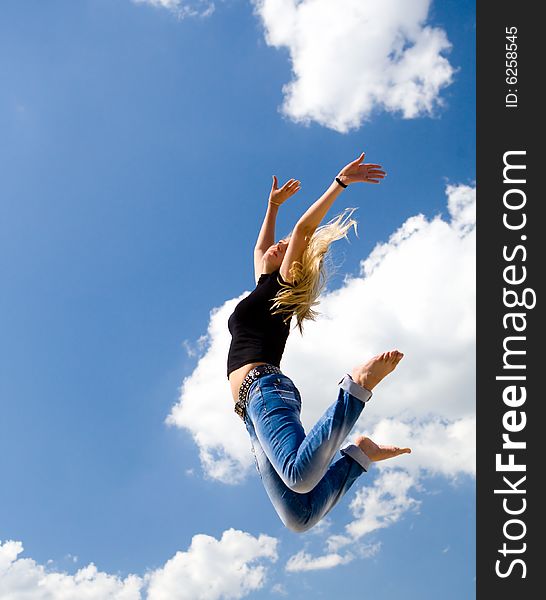 Pretty Girl Jumping On Blue Sky Background