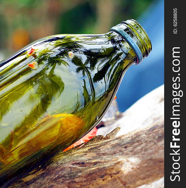 Beach scene reflected off green bottle. Beach scene reflected off green bottle