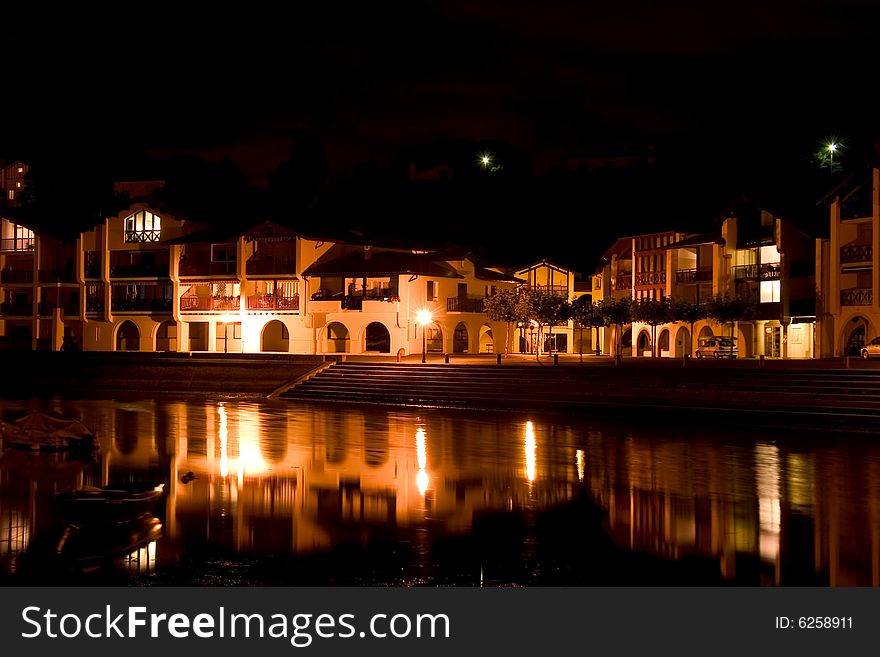 A village of white house at night near a river in the south of france. A village of white house at night near a river in the south of france