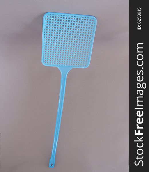 A blue fly swatter poised to strike!