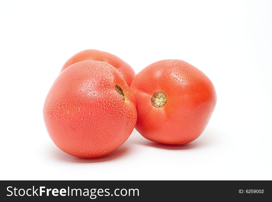 Three ripe tomatoes on white background