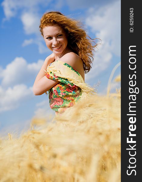 Beautiful red-haired girl on golden wheat field. Beautiful red-haired girl on golden wheat field