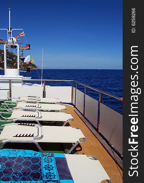 White sunbeds on board of a ferry boat. White sunbeds on board of a ferry boat