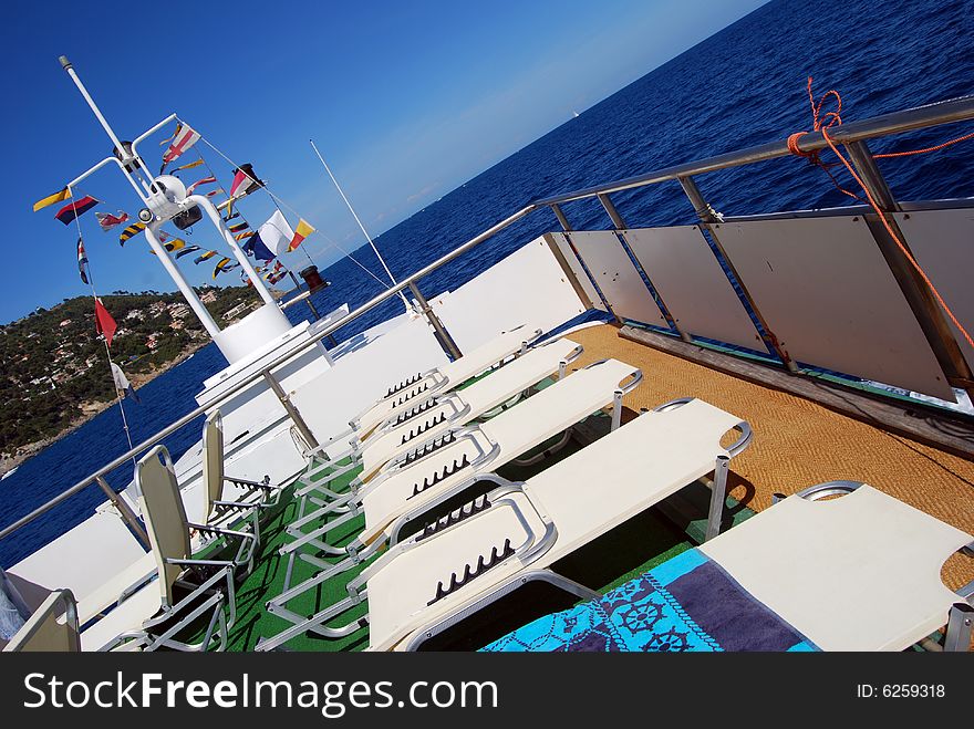 White sunbeds on board of a ferry boat. White sunbeds on board of a ferry boat