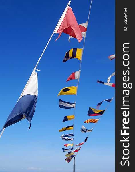 Coloured seafaring flags on a boat. These flags and their meaning costitutes the international code to communicate on sea. Coloured seafaring flags on a boat. These flags and their meaning costitutes the international code to communicate on sea.