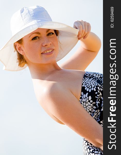 Beautiful young caucasian model with white hat at summer background. Beautiful young caucasian model with white hat at summer background
