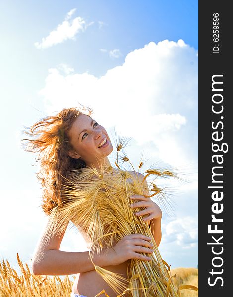 Beautiful red-haired girl on golden wheat field. Beautiful red-haired girl on golden wheat field