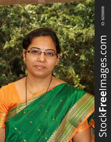 A simple Indian housewife in traditional clothes at the time of festival.