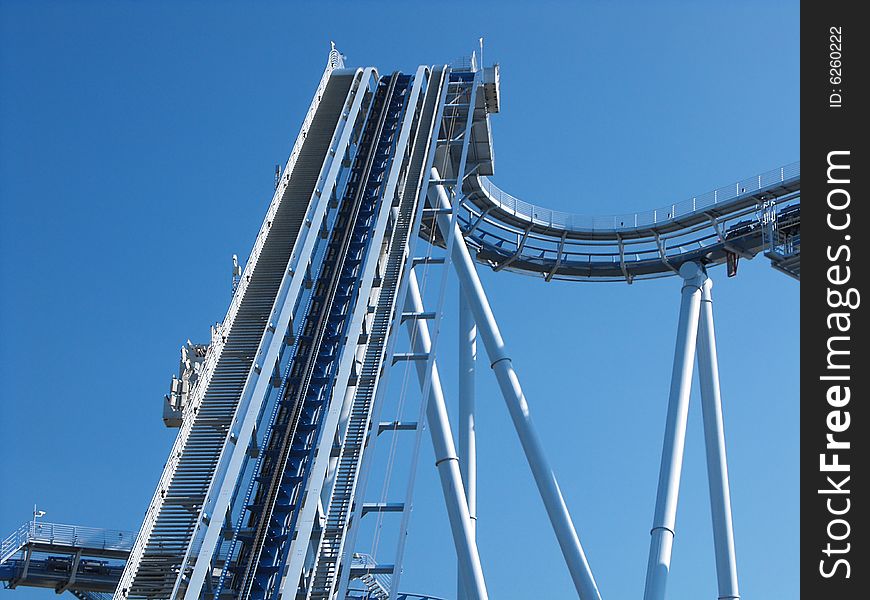 Blue twisted roller coaster track with beam support. Blue twisted roller coaster track with beam support.