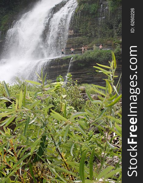 People playing near a waterfall. People playing near a waterfall