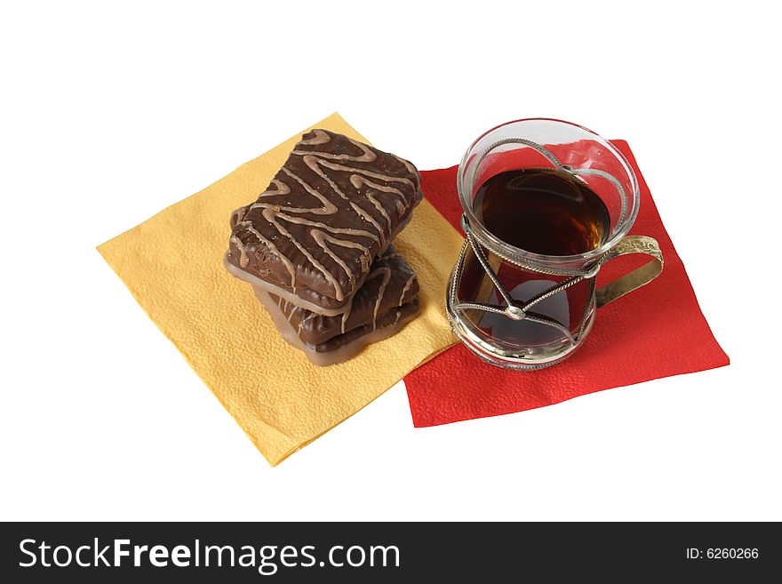 Cup of black tea and chocolate pastry on paper napkins. Cup of black tea and chocolate pastry on paper napkins