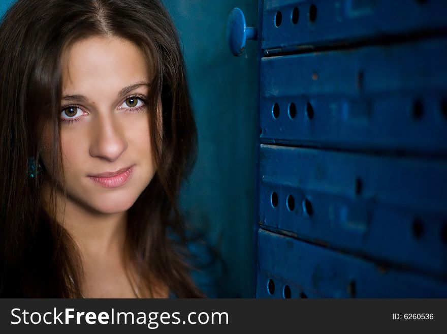 Nice girl is staing near mailbox and looking up with a smile. Nice girl is staing near mailbox and looking up with a smile