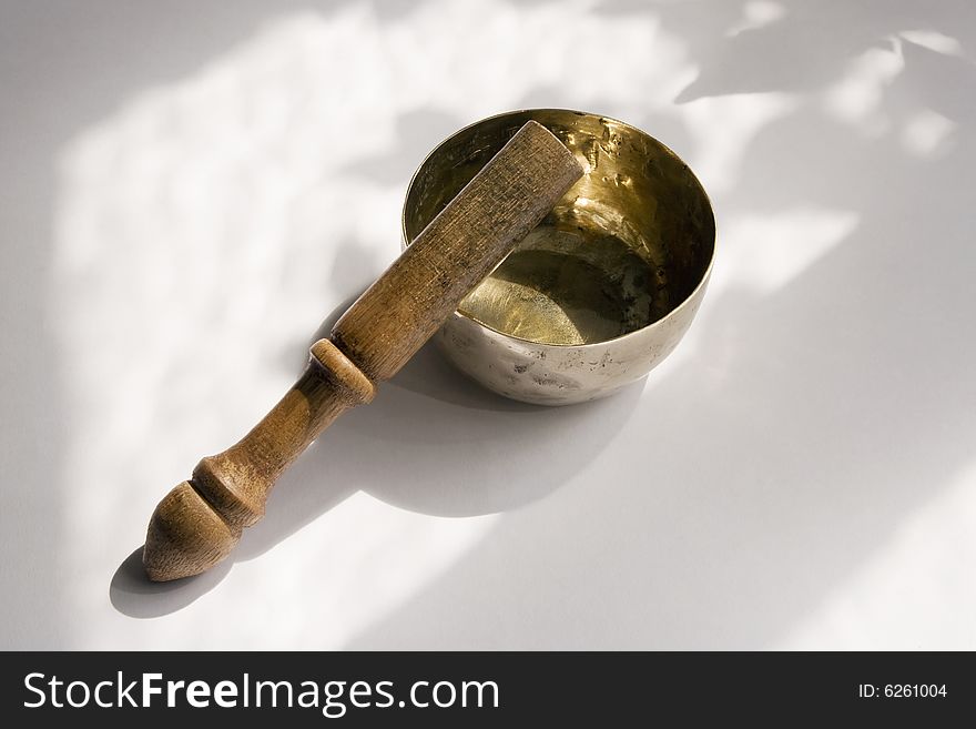 Bronze singing bowl or standing bell, with wooden mallet, used in Buddhist spiritual traditions, for meditation, relaxation, healthcare, personal well-being and religious practice. Bronze singing bowl or standing bell, with wooden mallet, used in Buddhist spiritual traditions, for meditation, relaxation, healthcare, personal well-being and religious practice.