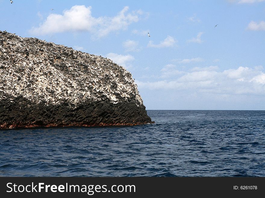 A large piece of volcanic rock in the ocean off the island of Fernando de Noronha. A large piece of volcanic rock in the ocean off the island of Fernando de Noronha