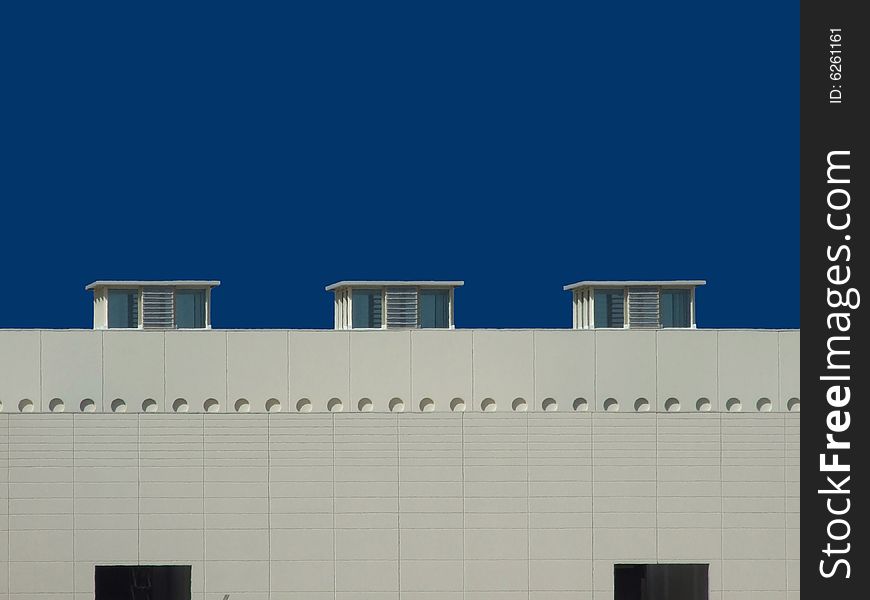 Industrial roof with skylight on a blue sky.