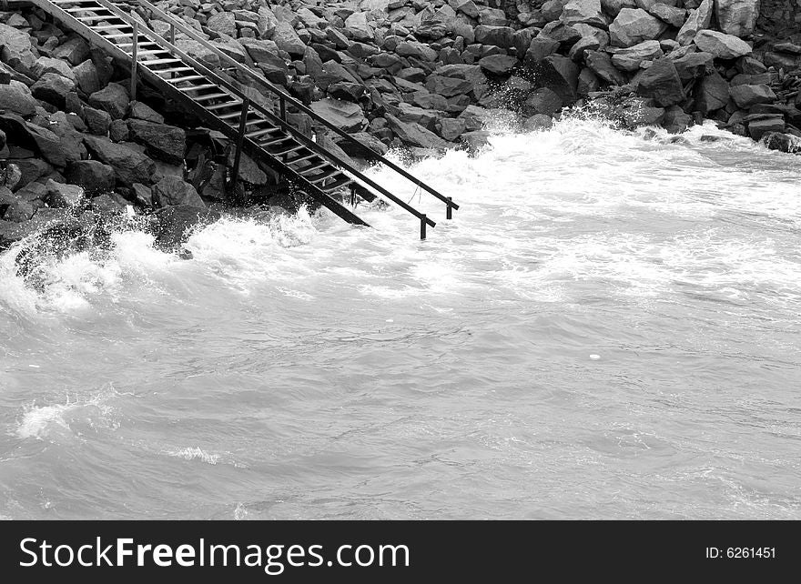 Black and white of stairs leading into the ocean. Black and white of stairs leading into the ocean