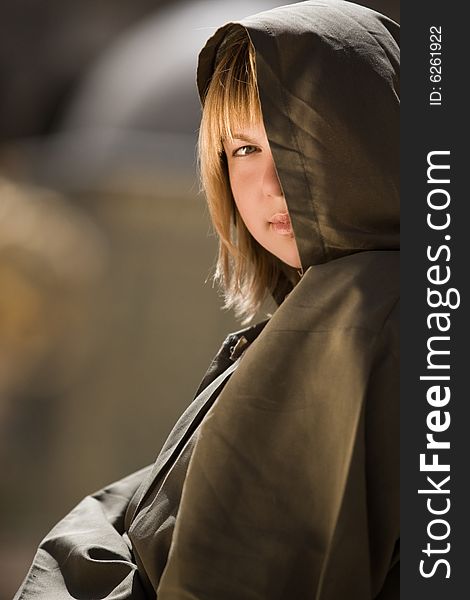 Mysterious girl in cassock and hood is looking