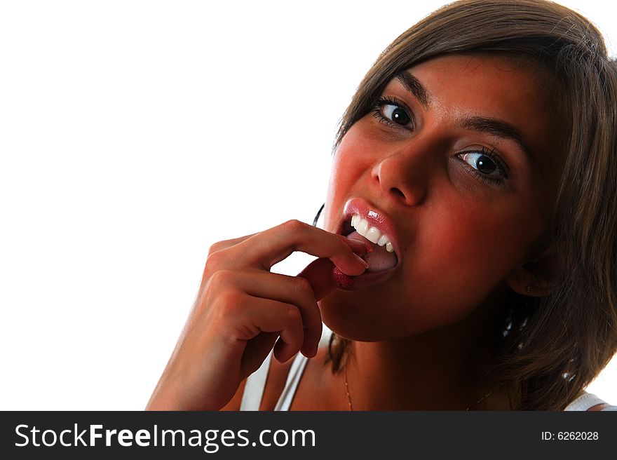 Attractive girl eating raspberry over white background