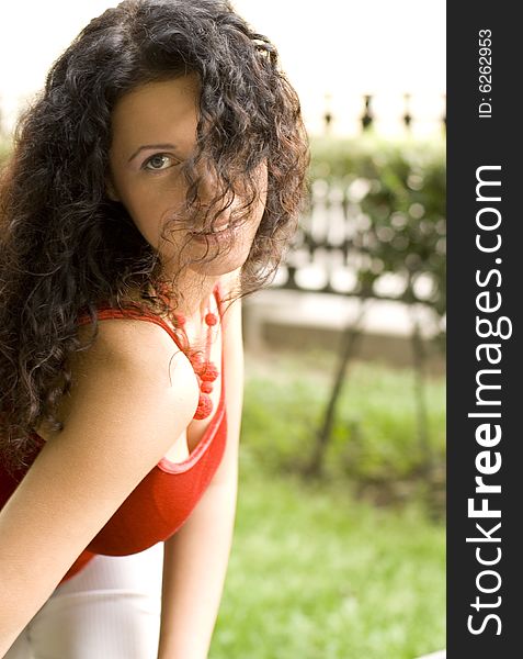 Outdoor portrait of beautiful brunet woman in red