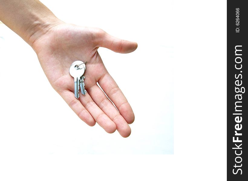 Close up of palm of hand holding two small silver keys, against white background. Close up of palm of hand holding two small silver keys, against white background.