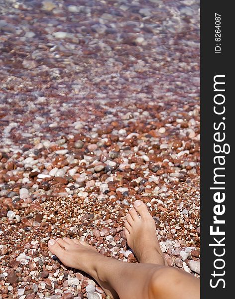 Gravel beach with relaxed legs