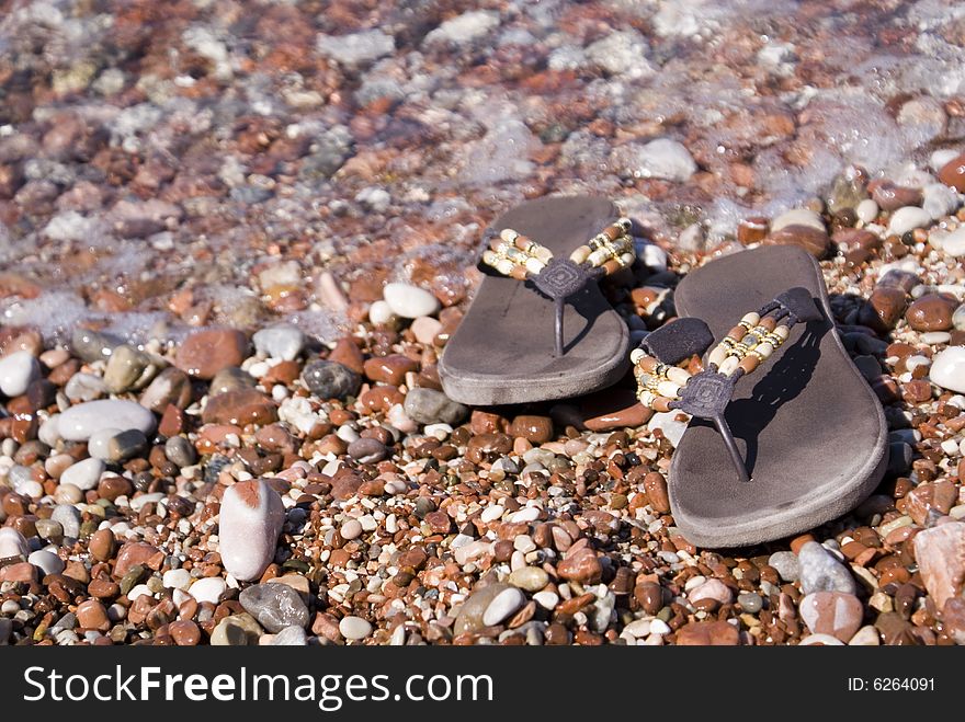 Gravel beach with flip-flops