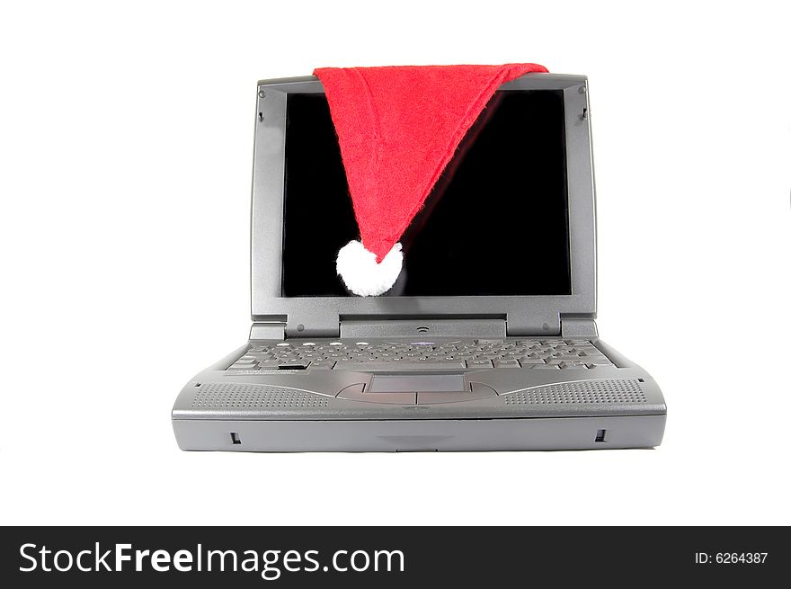 Santa's hat on a laptop isolated on white. Santa's hat on a laptop isolated on white