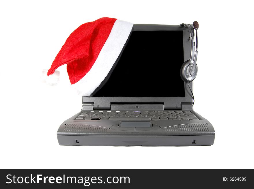 Laptop with christmas hat and earphones