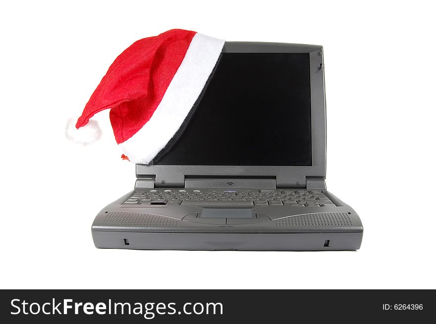 Santa's red hat on a laptop isolated on white. Santa's red hat on a laptop isolated on white