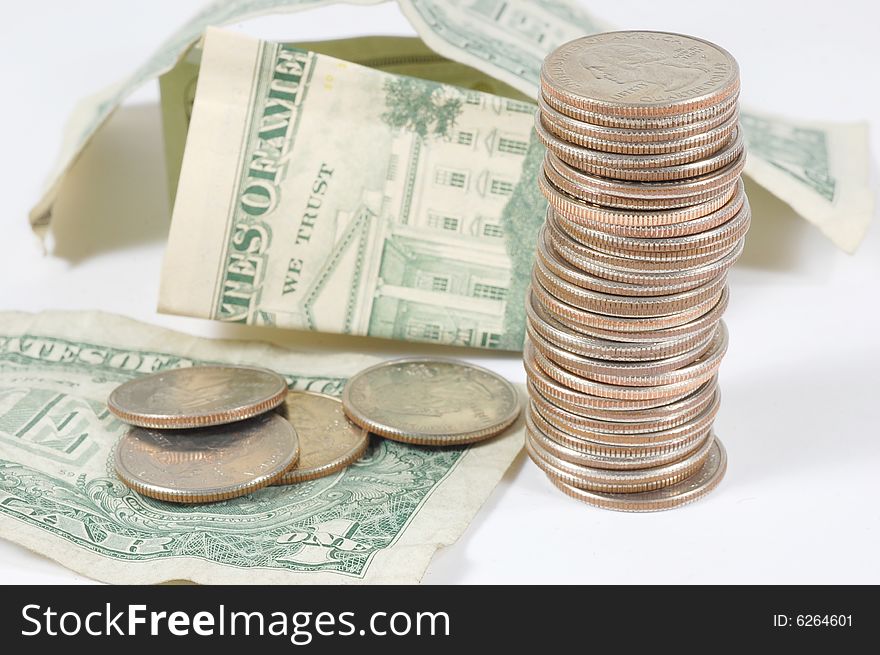 Dollar bills and quarters isolated on a white background. Dollar bills and quarters isolated on a white background