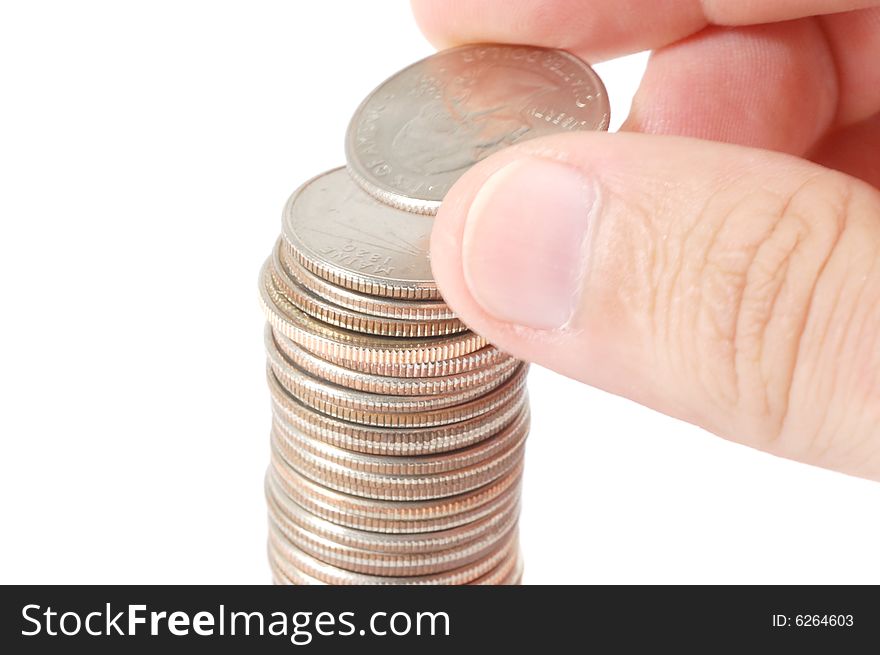 Hand building a tower of quarters isolated on a white background. Hand building a tower of quarters isolated on a white background