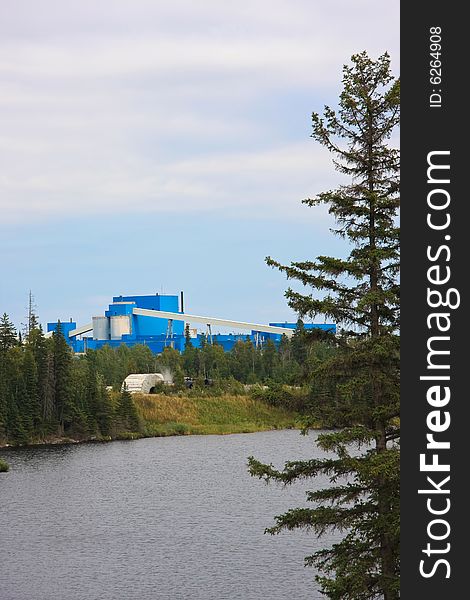 Blue mine buildings on a river