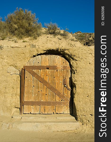 Antique door of a house carved in a cliff in patagonia, argentina.