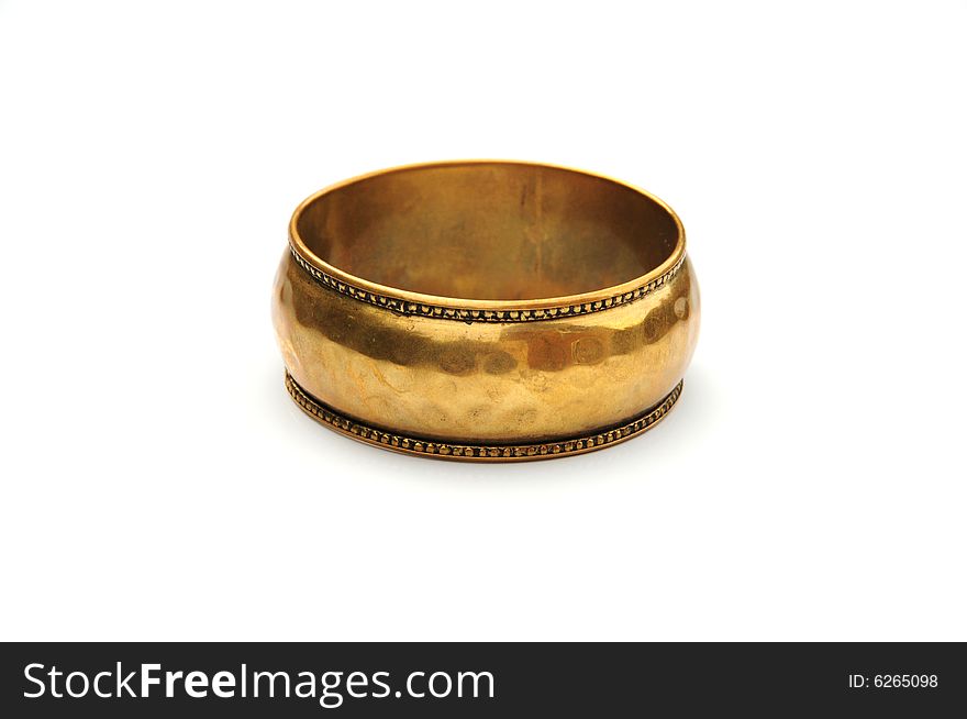 Shot of a gold coloured bangle isolated on white