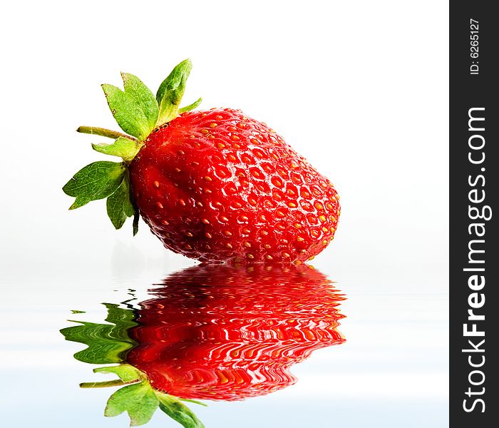 An image of red strawberry in water close up