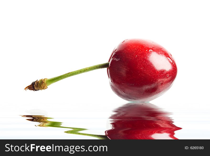 An image of red berry in a water close up. An image of red berry in a water close up