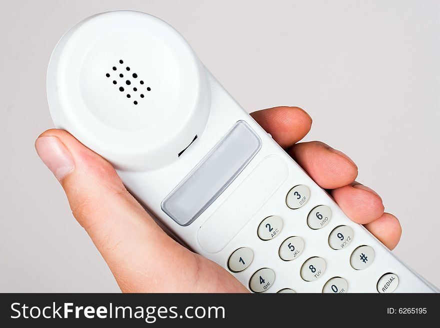 An image of telephone in mans hand. An image of telephone in mans hand