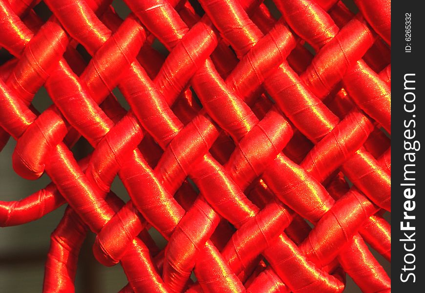 Grid weaved from a red satiny tape