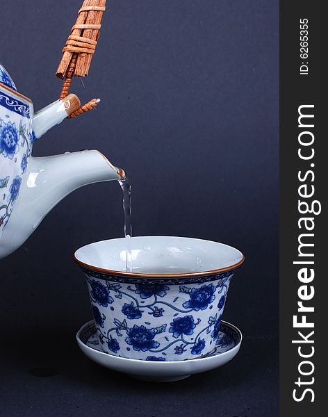 Pouring tea into a Chinese teacup. Pouring tea into a Chinese teacup