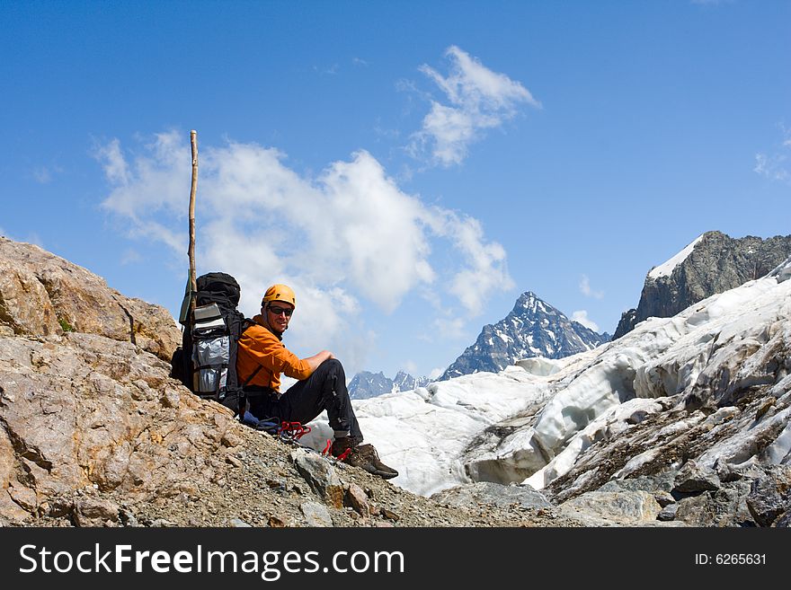 Tourist Sitting On Cliff