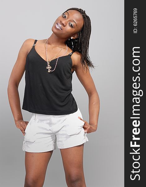 Attractive young African girl posing in white skirt, dark top