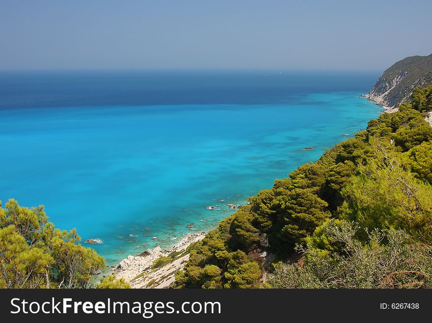 Turquoise and blue waters at the western coast of Lefkada island (Pefkakia area), at the Ionian sea, Greece. Turquoise and blue waters at the western coast of Lefkada island (Pefkakia area), at the Ionian sea, Greece