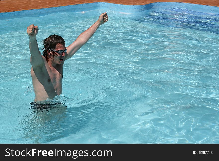 Young wan in the pool happy becourse of his succes. Young wan in the pool happy becourse of his succes