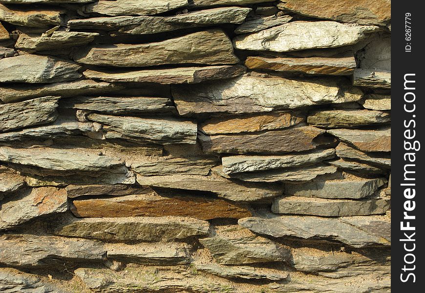 Fragment of rustic stone wall surface texture. Fragment of rustic stone wall surface texture