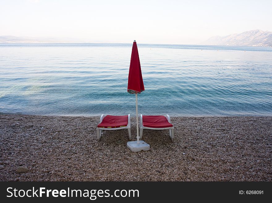 Chaises On The Empty Beach